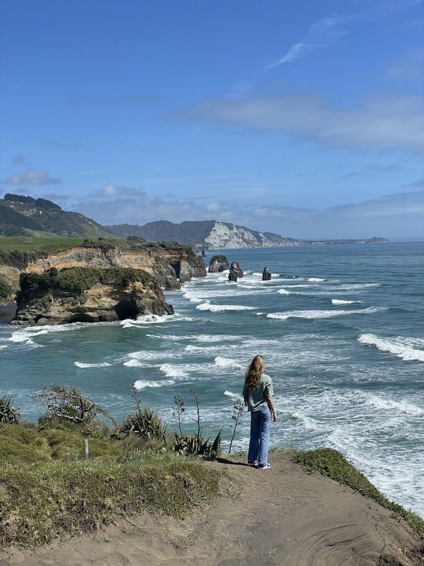 Emma standing on a coastal cliff